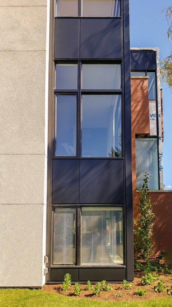 Aluminaire Panels,Prefinished Cladding,Residential Building Materials,Automated Exterior Panels,Precision Manufacturing,Black Panel Project,Superior Durability Panels,Advanced Exterior Solutions,Residential Staircase Design,Architectural Excellence