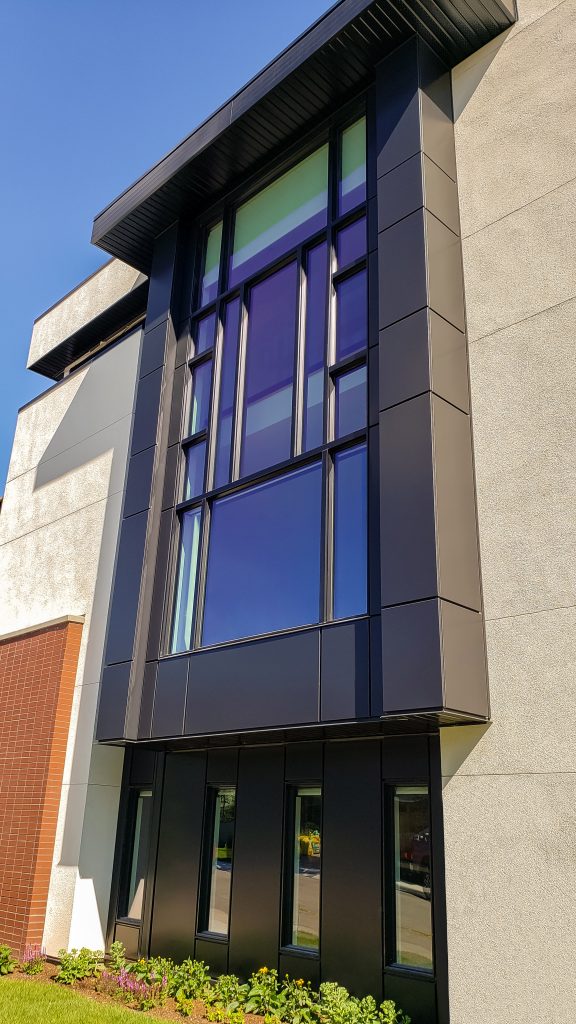 Aluminaire Panels,Prefinished Cladding,Residential Building Materials,Automated Exterior Panels,Precision Manufacturing,Black Panel Project,Superior Durability Panels,Advanced Exterior Solutions,Residential Staircase Design,Architectural Excellence